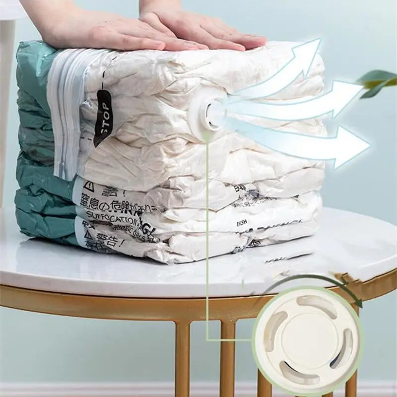 Hands compressing vacuum storage bag showing air release valve