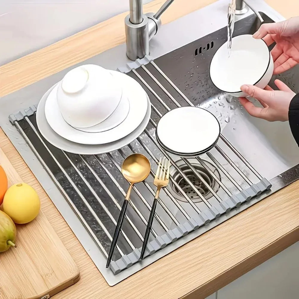 Roll up dish drying rack holding plates and utensils over the sink