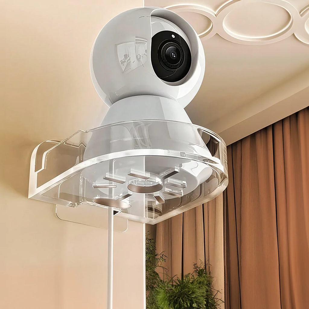CCTV camera wall mount holding a white security camera in a clear no-drill bracket