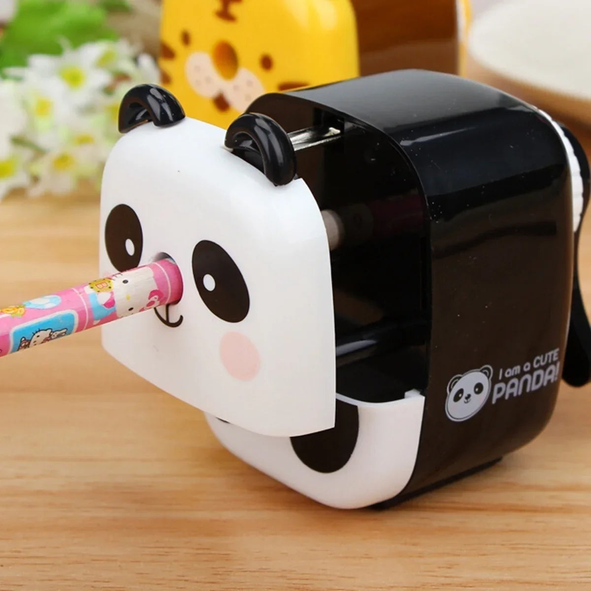 Panda animal pencil sharpener sharpening a pencil