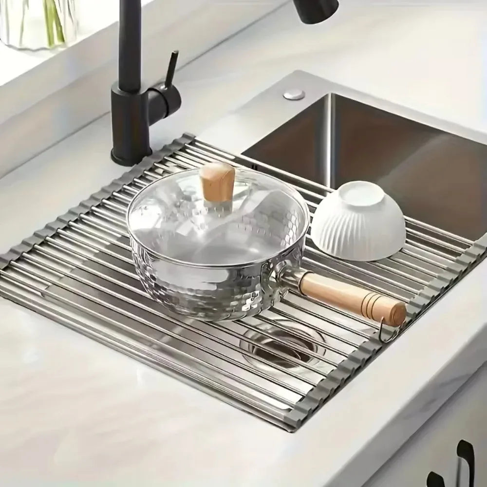 Stainless steel roll up dish drying rack with a pot and bowl on the sink