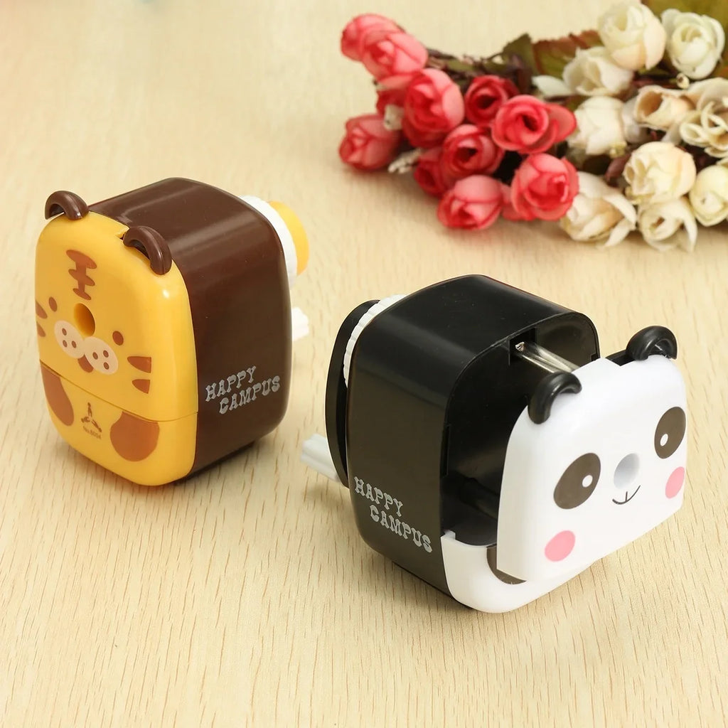 Panda and tiger animal pencil sharpeners on a desk
