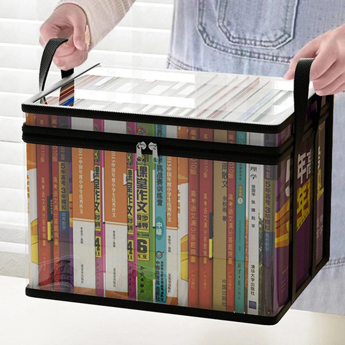 Hands carrying book storage box by handles