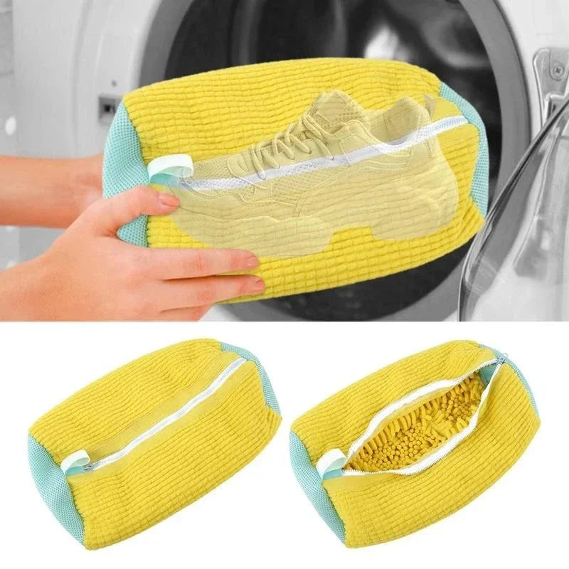 Hands holding a yellow mesh laundry shoe bag with a sneaker in front of a washer