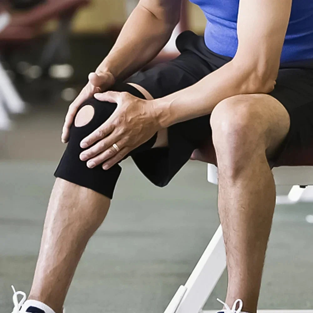 Athlete wearing basketball knee pad while seated