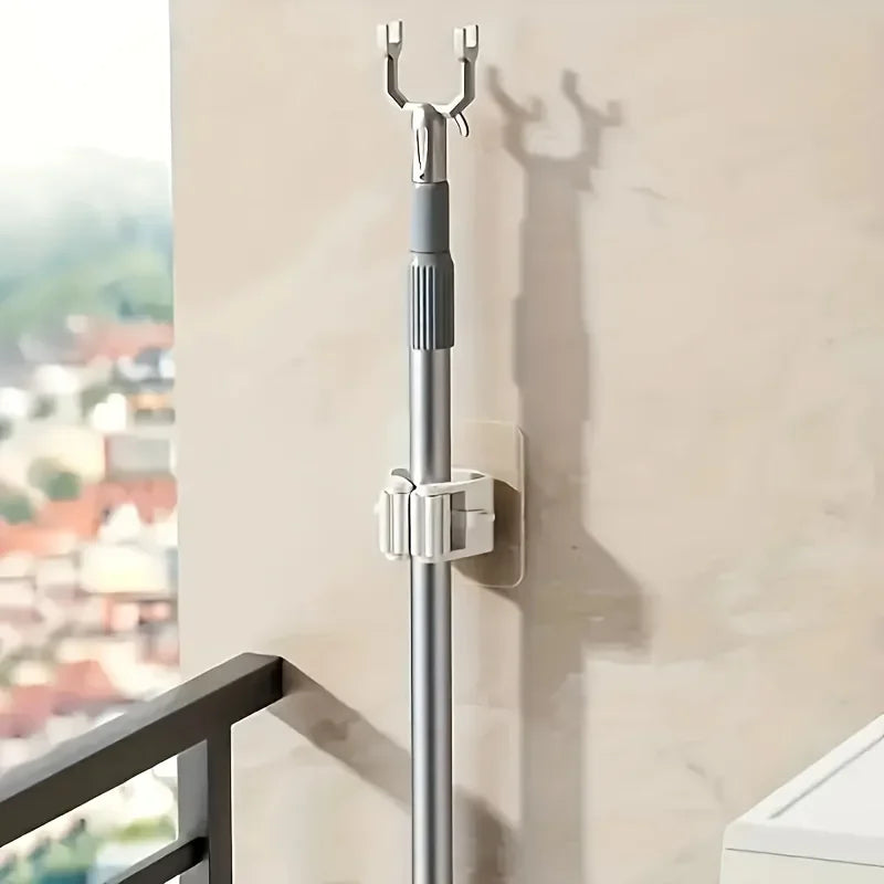 Wall mounted mop holder installed on a wall with a mop