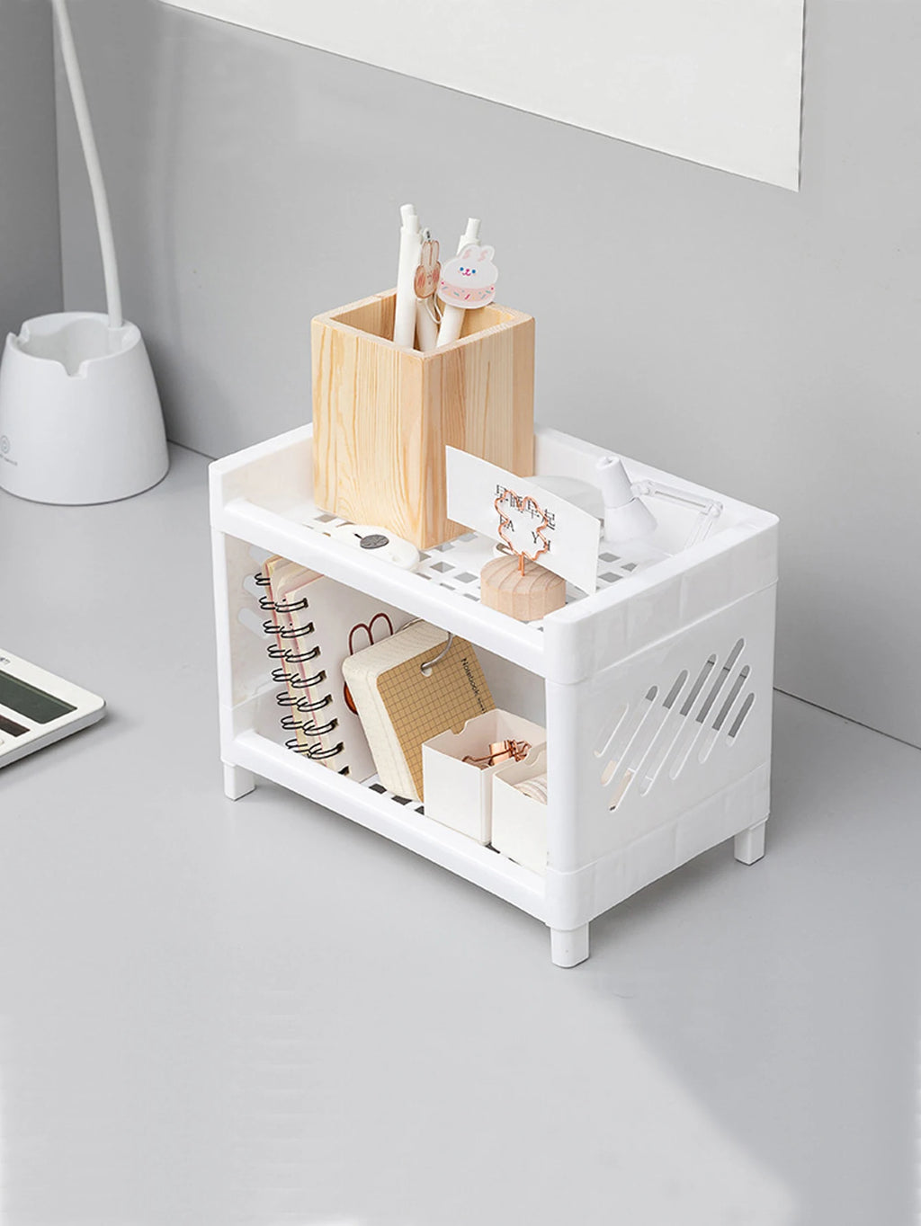 Angled view of white desktop organizer with stationery