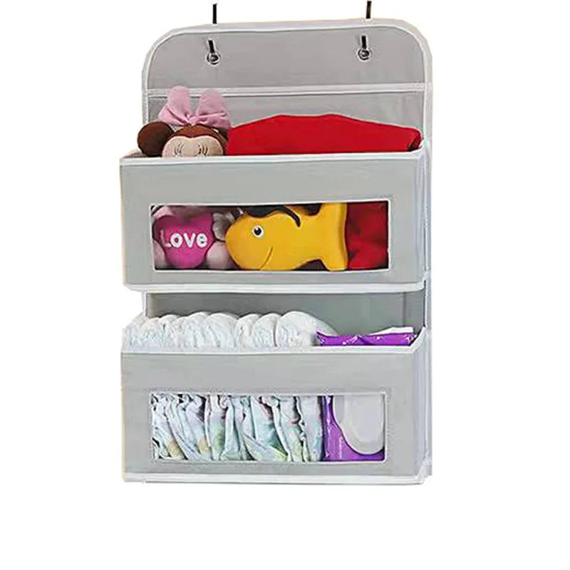 Grey 3-pocket hanging door organizer with clear windows for baby clothes and diapers