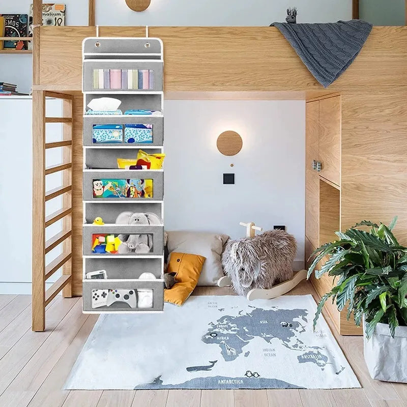 Grey hanging closet organizer beside a kids loft bed with toys and clothes