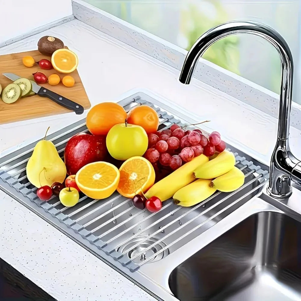 Roll up dish drying rack drying colorful fruit over a kitchen sink