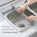 Roll up dish drying rack unfolded over a kitchen sink, easy to use