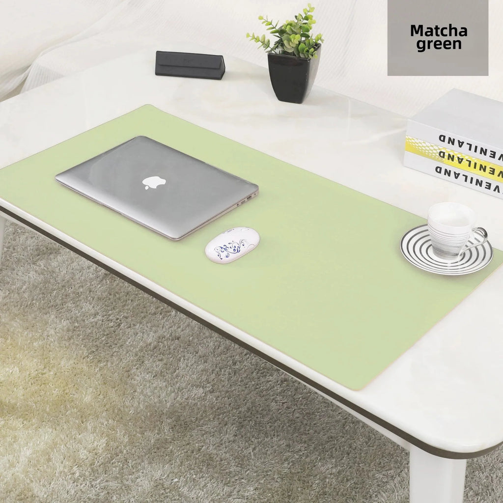 Matcha green leather desk pad on white desk with laptop